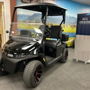 2026 E-Z-GO Freedom ELiTE Lithium in gloss Black, 2-seater golf cart with custom black and red alloy wheels, front three-quarter view