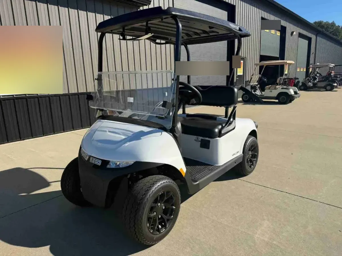 2026 E-Z-GO RXV Valor 2 S+ in White, front angle with LED headlights and black alloy wheels