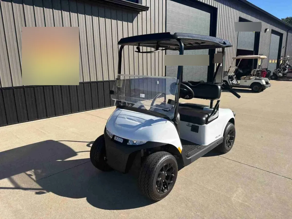 2026 E-Z-GO RXV Valor 2 S+ in White, 2-seater electric golf cart with windscreen, front three-quarter view