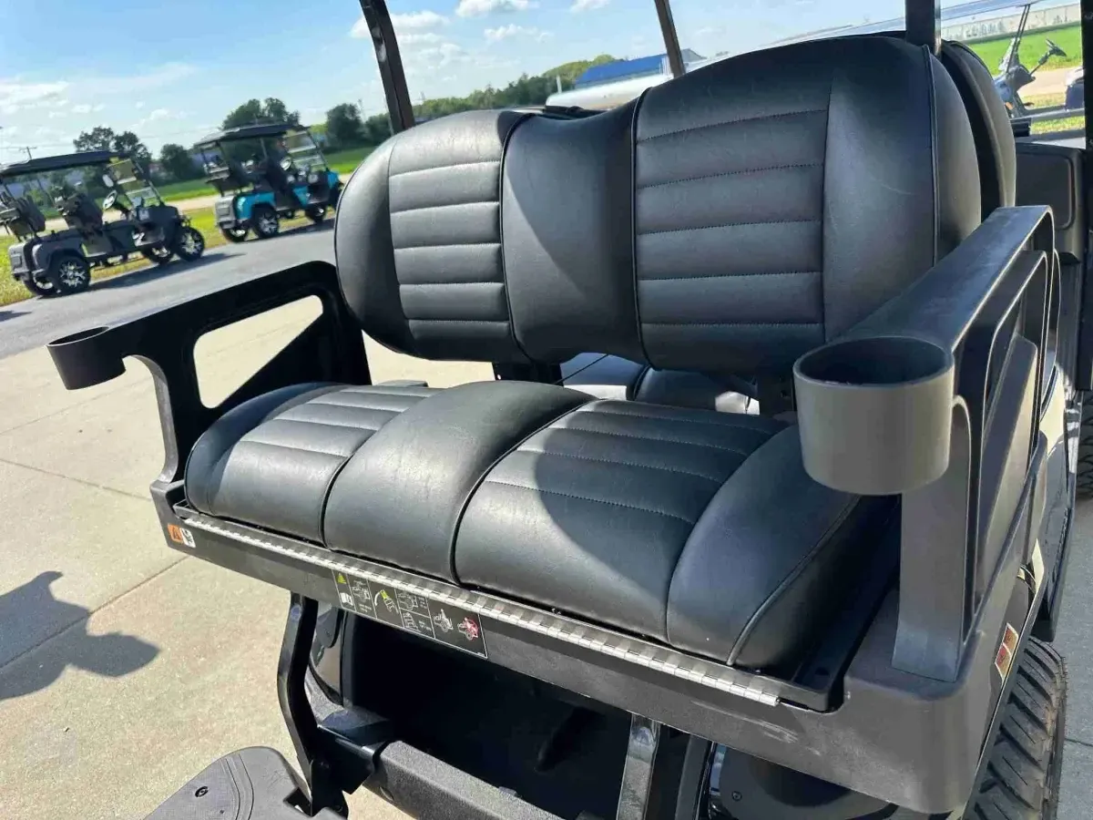 Rear flip seat with grab handles and cup holders on the 2027 E-Z-GO Express 4 Summit XT