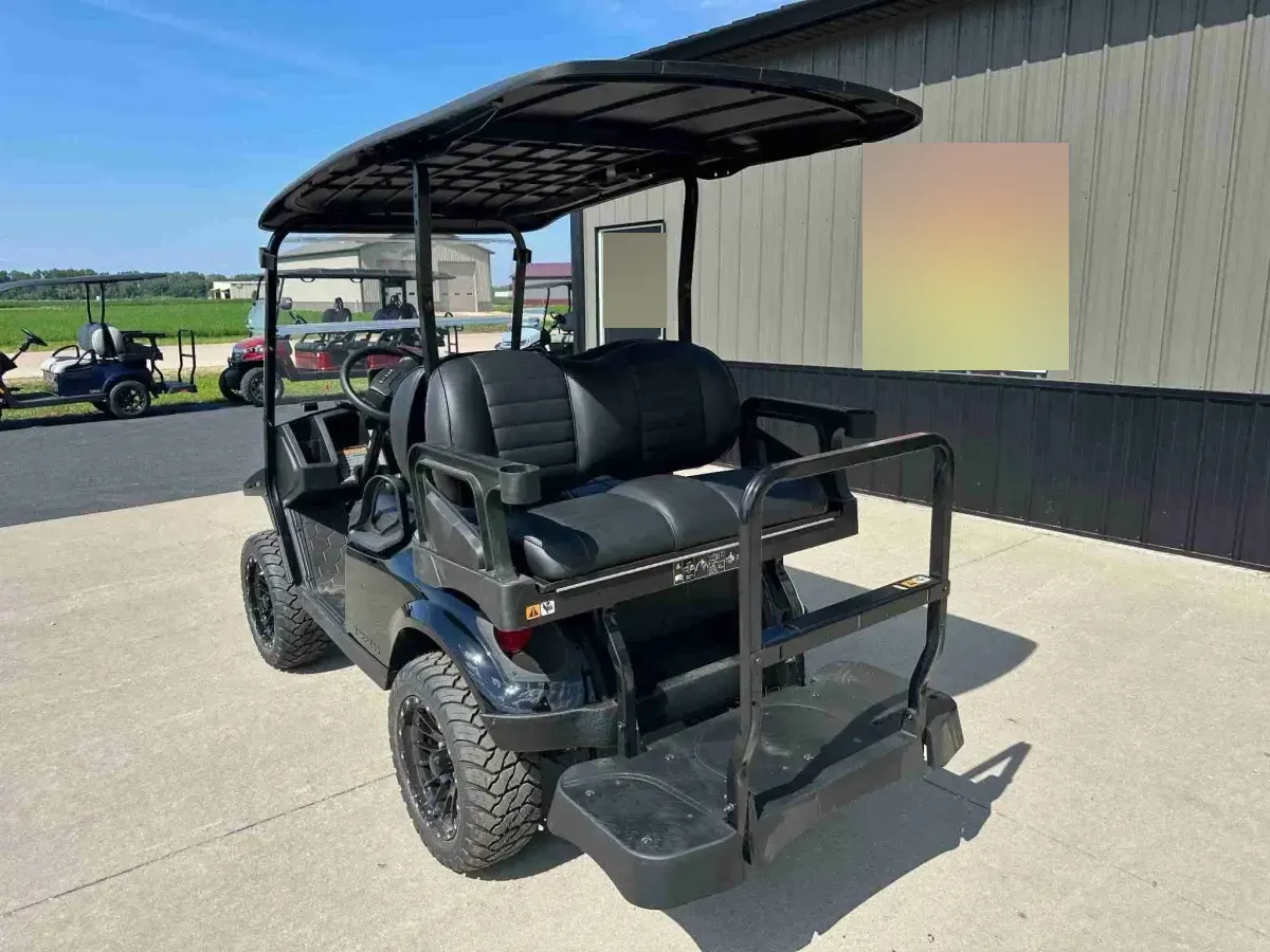Rear-facing seat of the 2027 E-Z-GO Express 4 Summit XT with black cushions