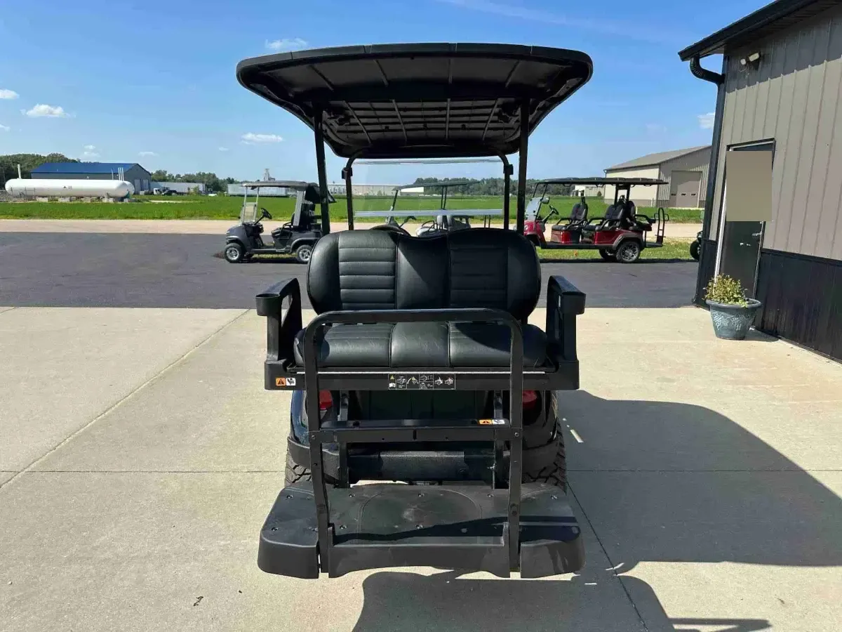 2027 E-Z-GO Express 4 Summit XT in Black, rear view with flip seat and footrest