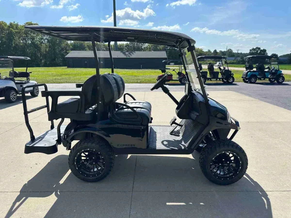 2027 E-Z-GO Express 4 Summit XT in Black, side view with black seats and off-road tyres