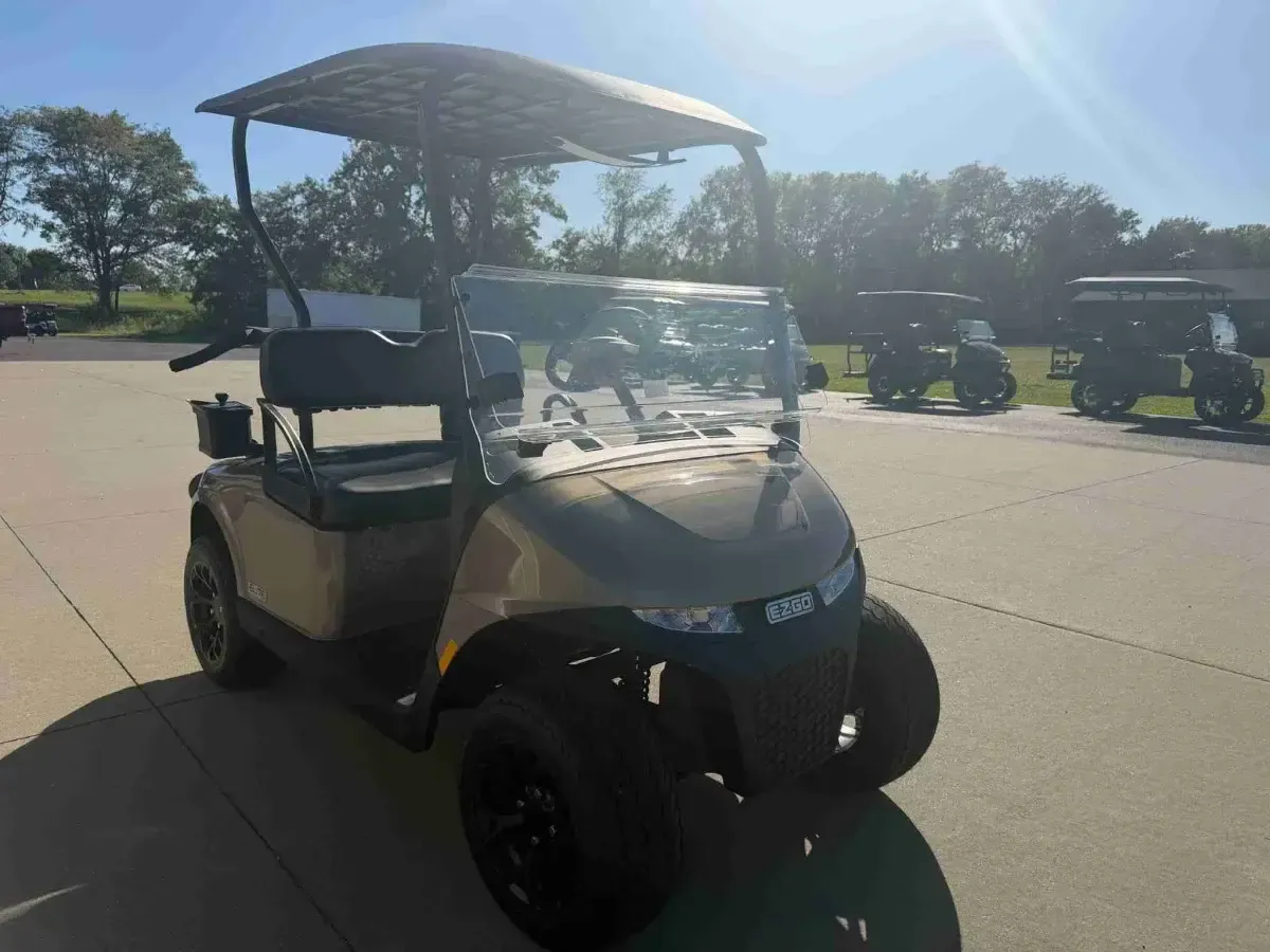 2027 E-Z-GO RXV Touring ELiTE Lithium in Bronze, 2-seater lithium golf cart with windscreen, front three-quarter view