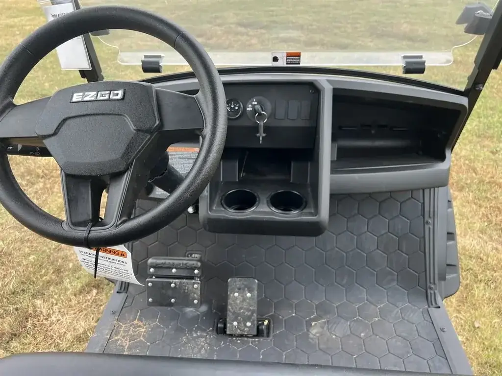 Steering wheel and dashboard with cup holders on the E-Z-GO Express 6 Summit X