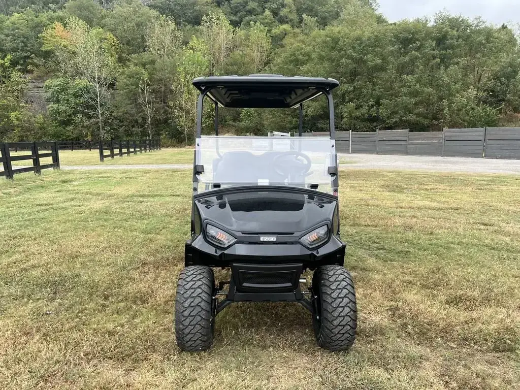 Front of the black E-Z-GO Express 6 Summit X with LED headlights and off-road tyres