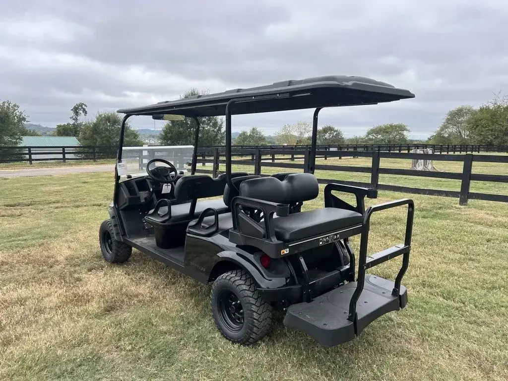 Rear three-quarter view of the E-Z-GO Express 6 Summit X with rear-facing seat