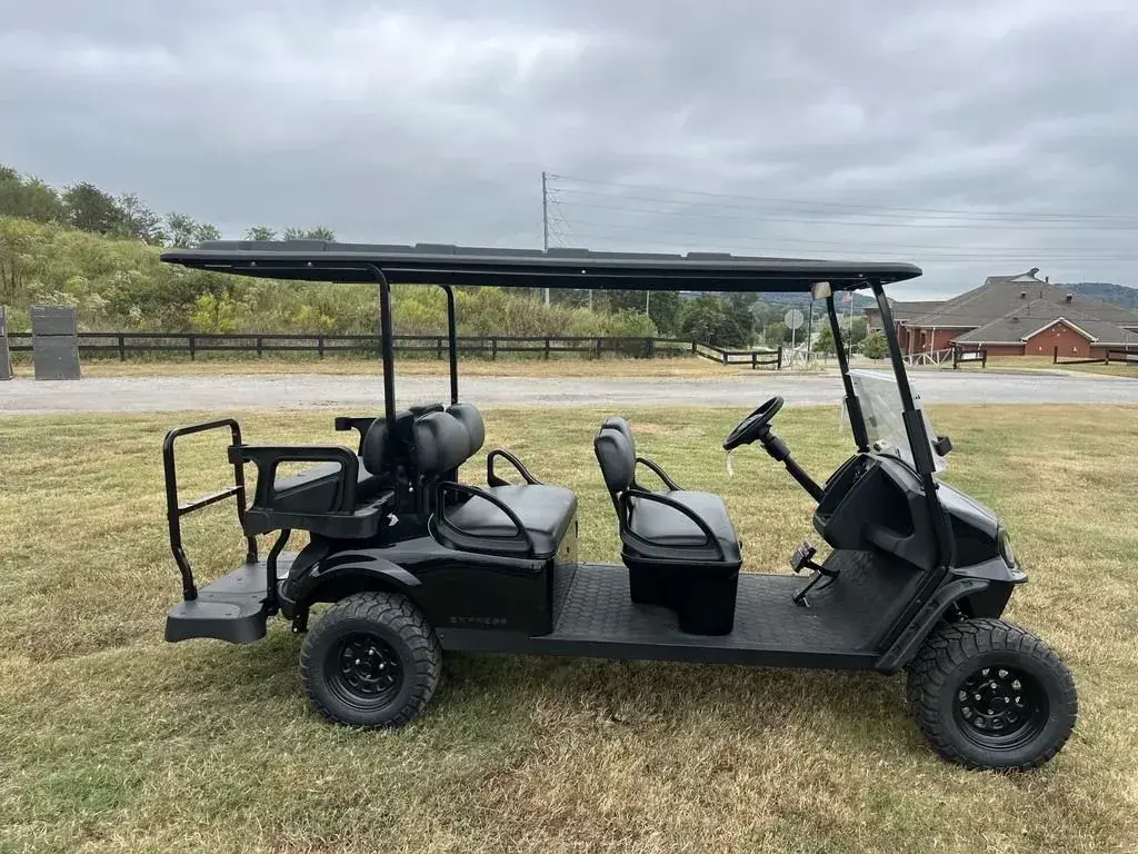 Right side view of the E-Z-GO Express 6 Summit X showing three rows of black seats