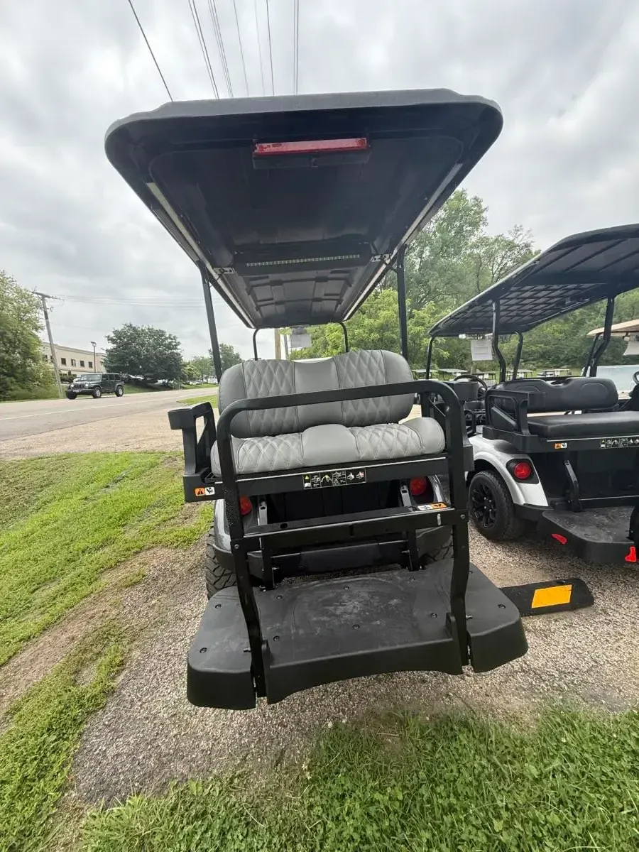 Rear of the E-Z-GO Express 6 Summit XT with rear-facing seat and roof light bar