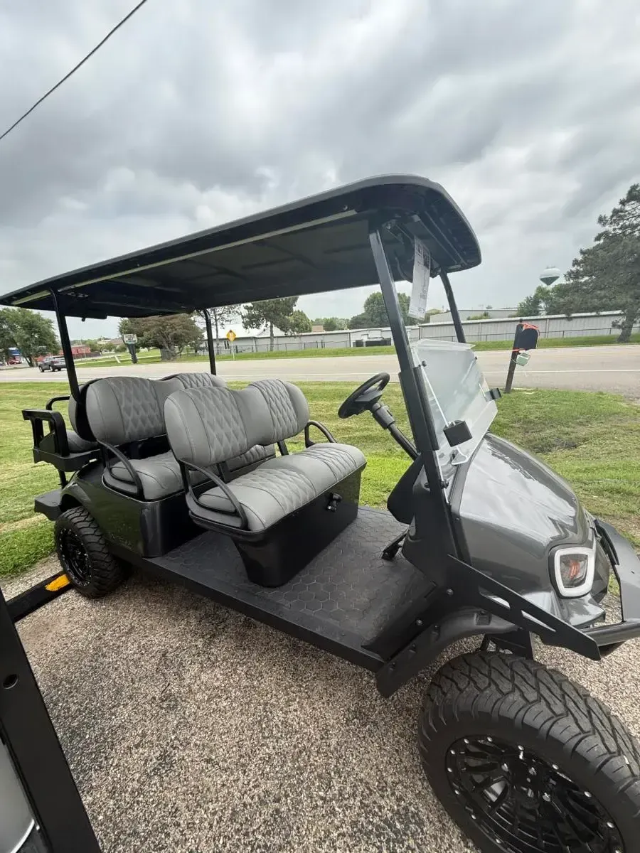 Side view of the E-Z-GO Express 6 Summit XT showing its three rows of quilted seats