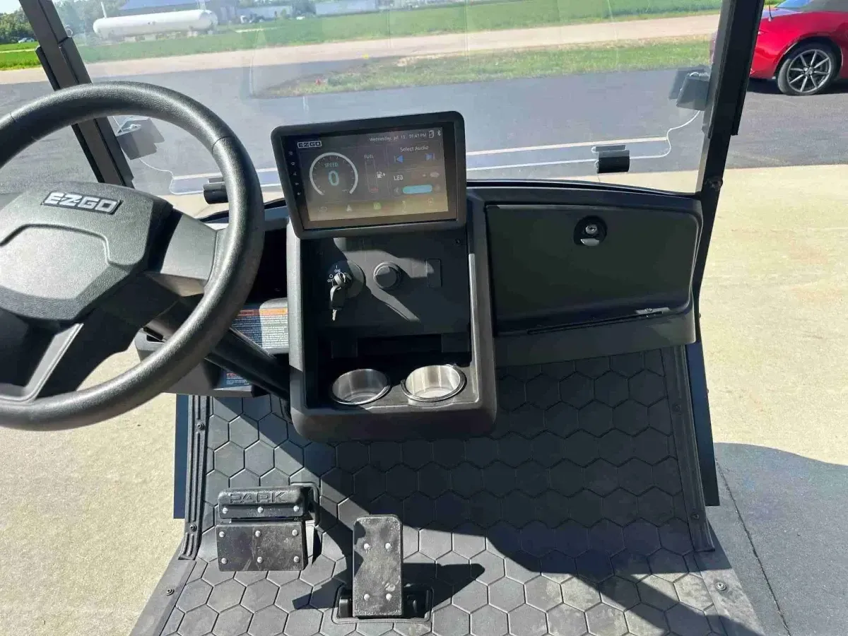 Dashboard of the E-Z-GO Express 6 Touring ST with steering wheel and centre touchscreen