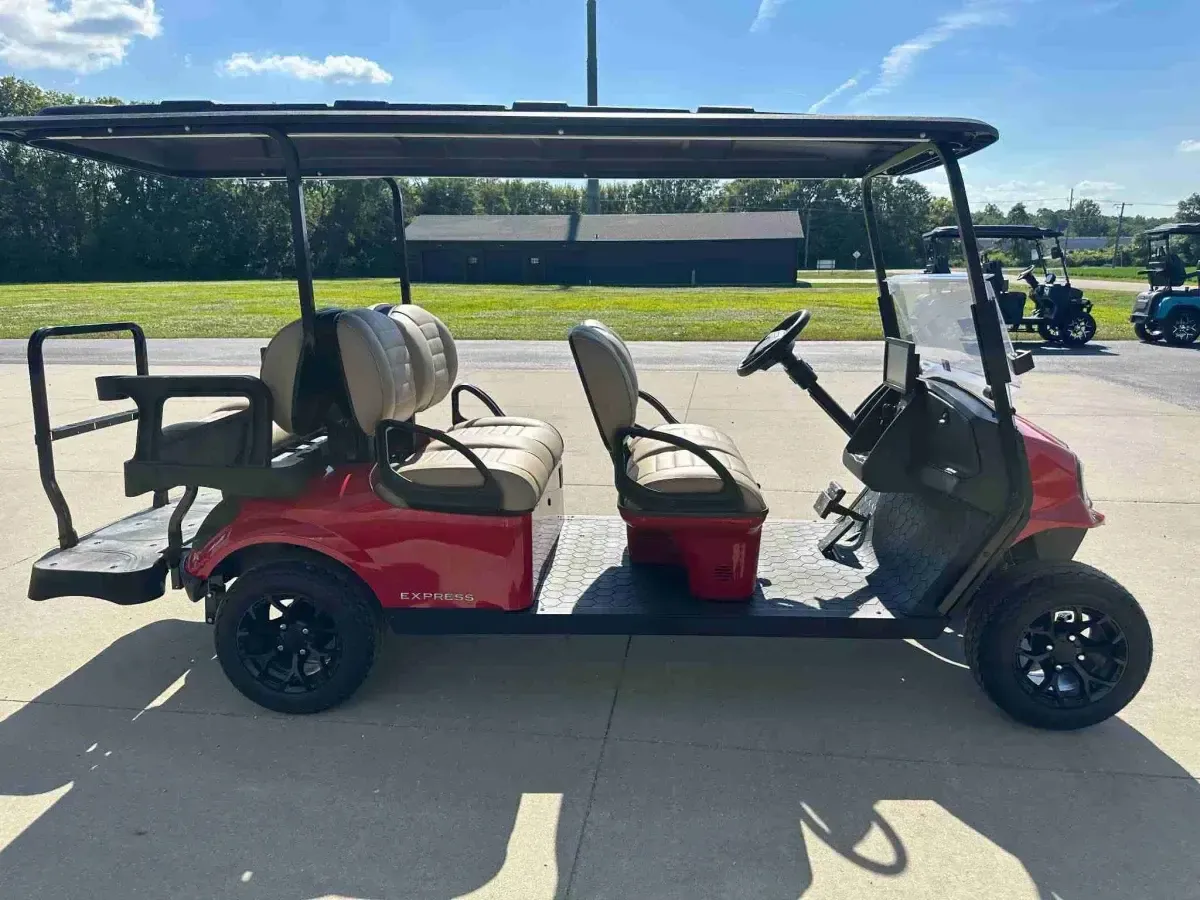 Side profile of the red E-Z-GO Express 6 Touring ST six-seater golf cart